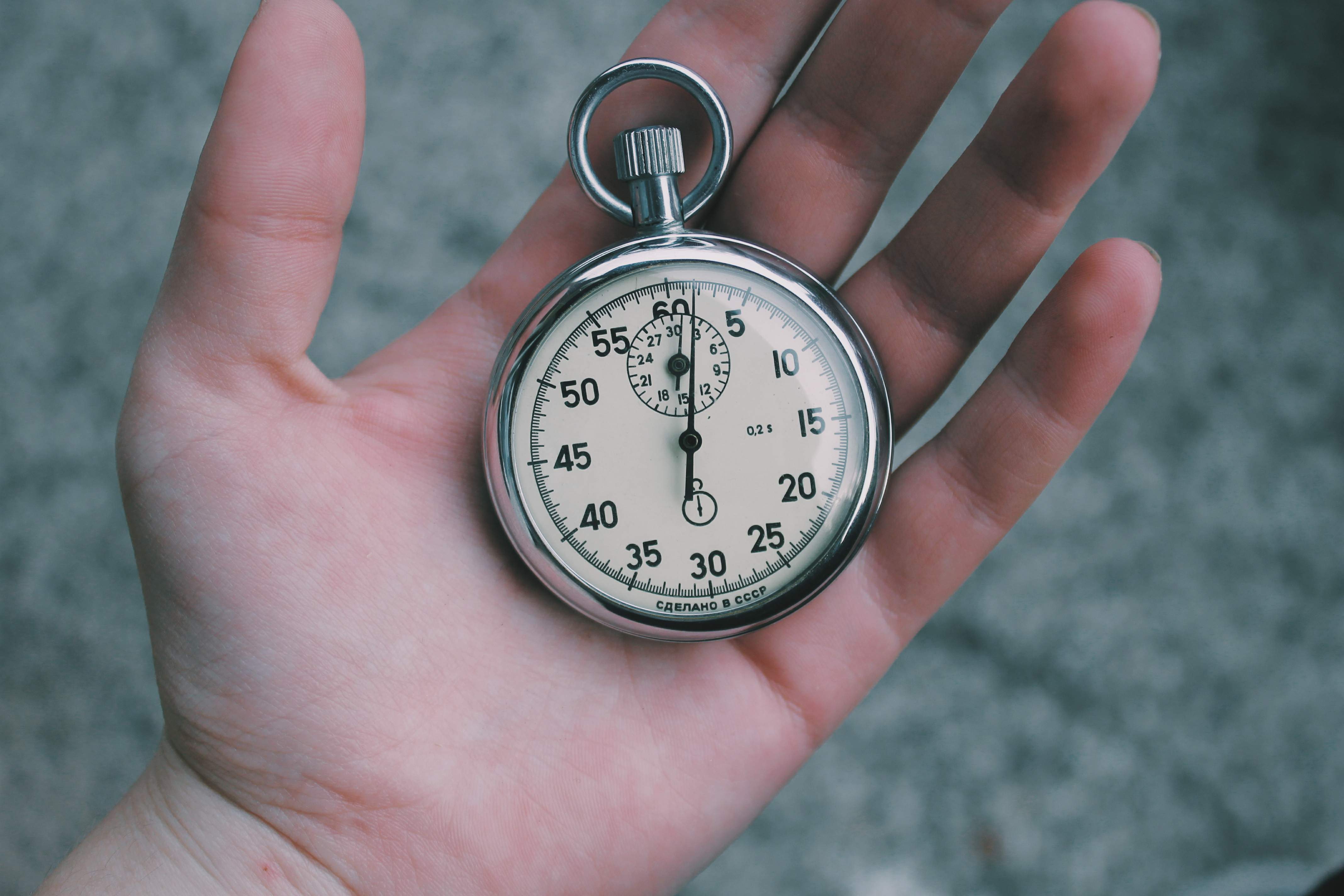 A stopwatch held in an open hand