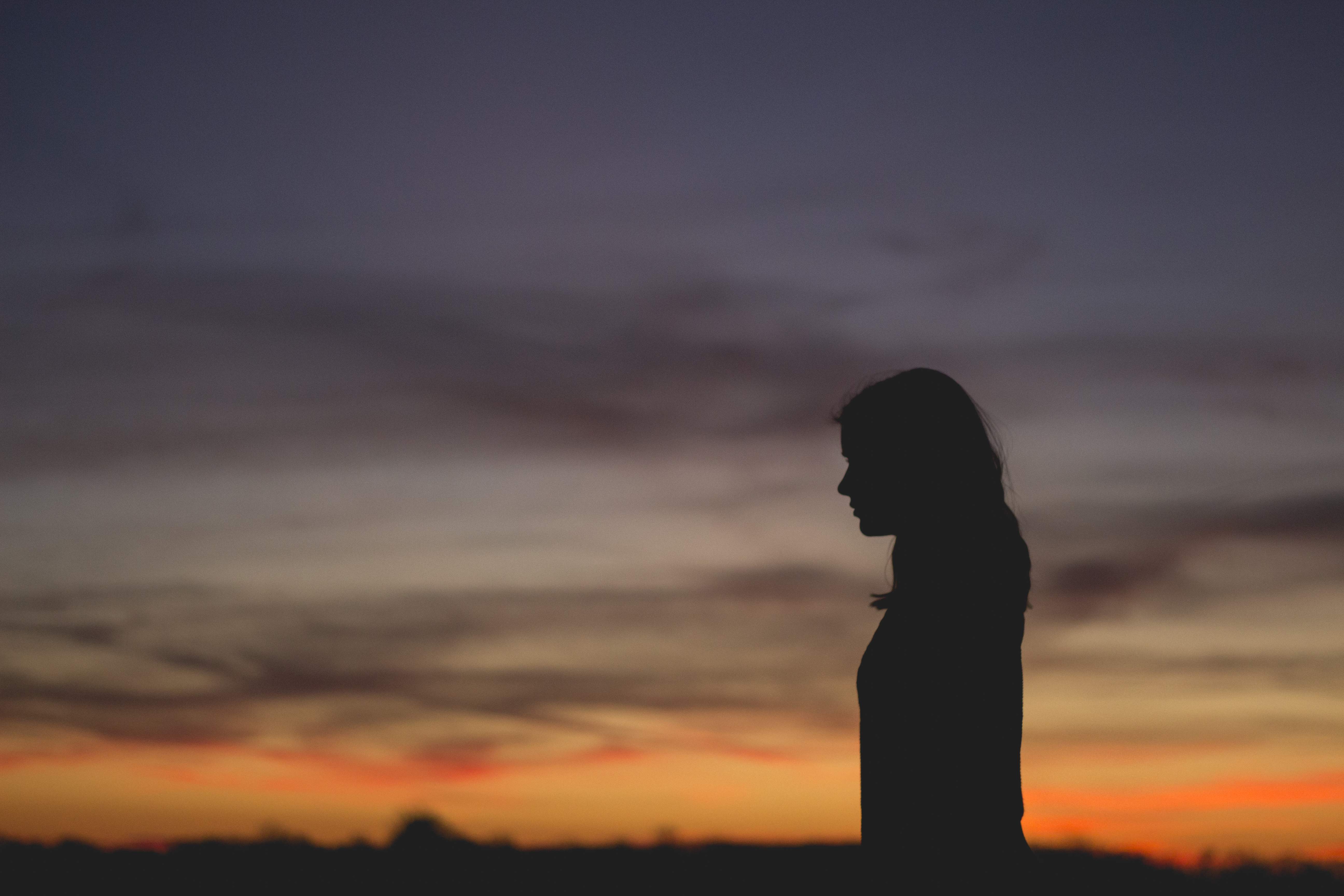 Silhouette of a woman at sunset